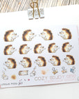 closeup of watercolor stickers - reading hedgehogs