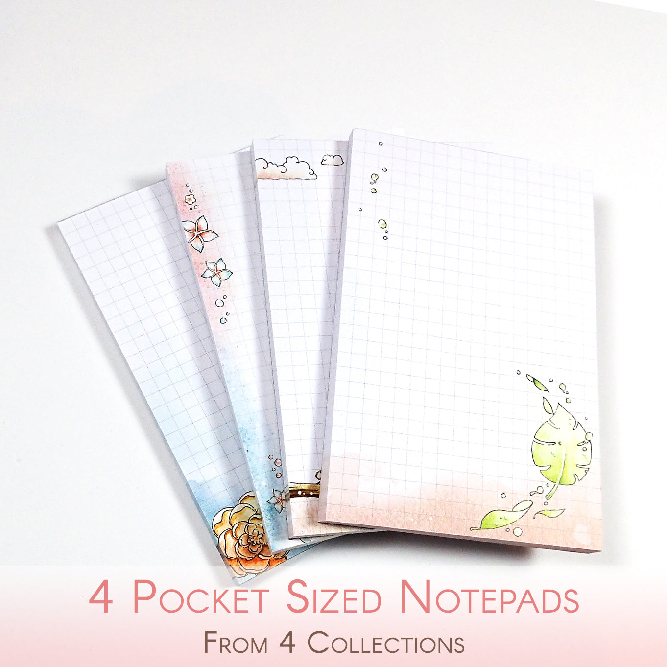 Four watercolored grid notepads pocket sized