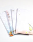 Four watercolored grid notepads pocket sized