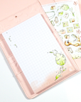 Four watercolored grid notepads pocket sized