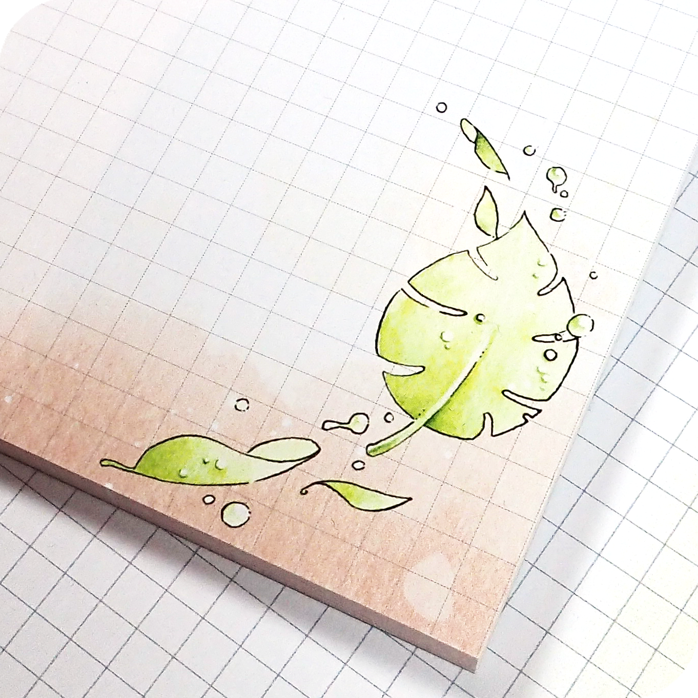 Four watercolored grid notepads pocket sized