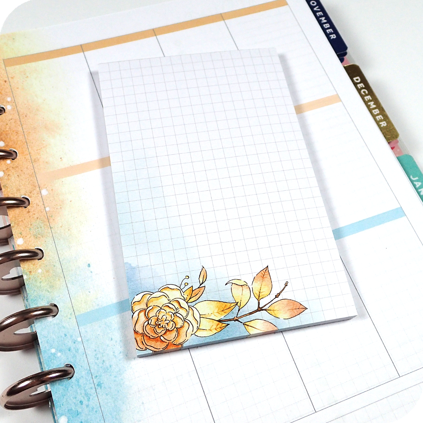 Four watercolored grid notepads pocket sized